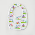 A white baby bib with a repeating pattern of Sharks and helmets with mega phonees on a light gray background. The bib has a white snap closure at the top and a small side tag that reads 'mimi's craft'.