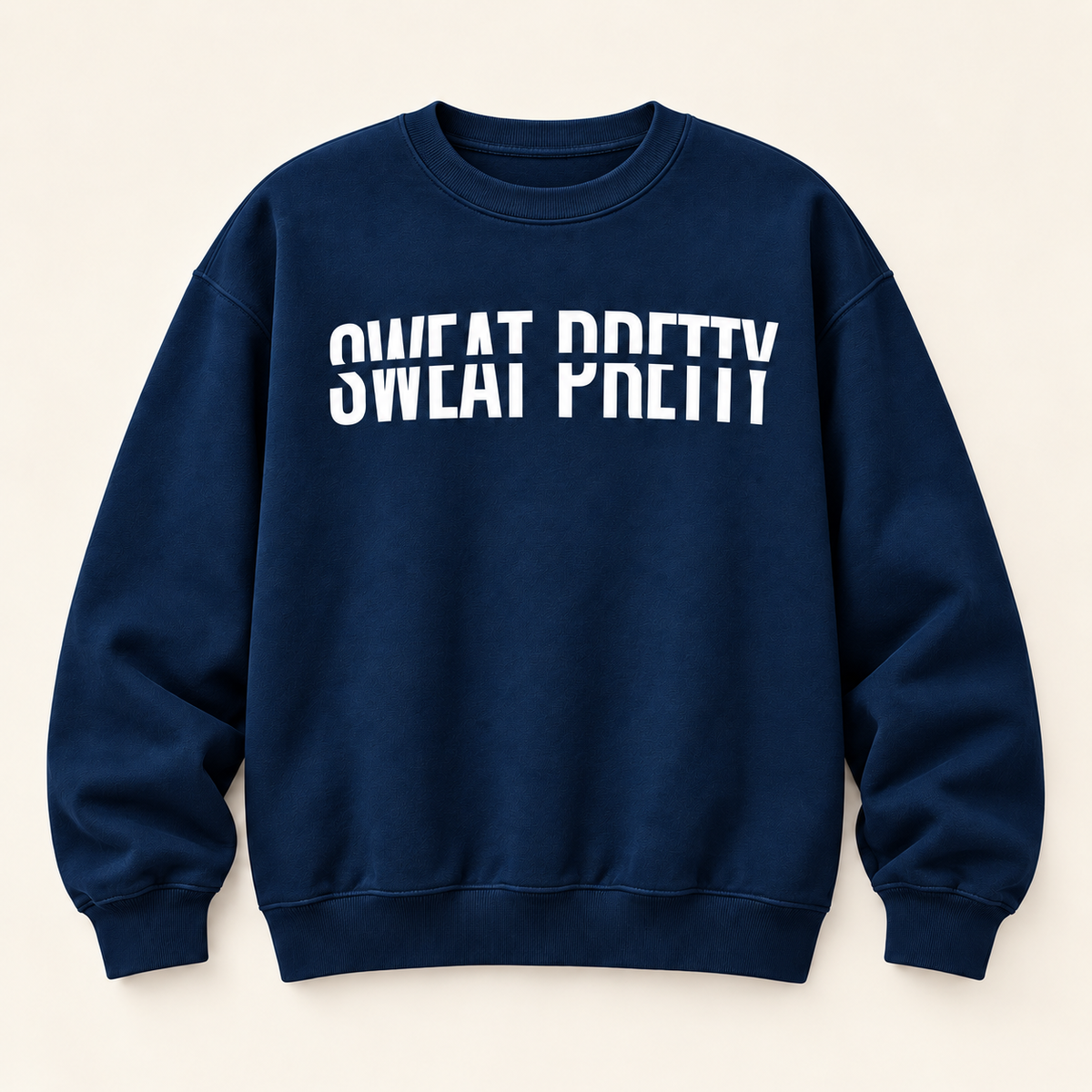 A navy blue crewneck sweatshirt with the phrase 'SWEAT PRETTY' printed across the chest in bold white letters, displayed flat against a light beige background.