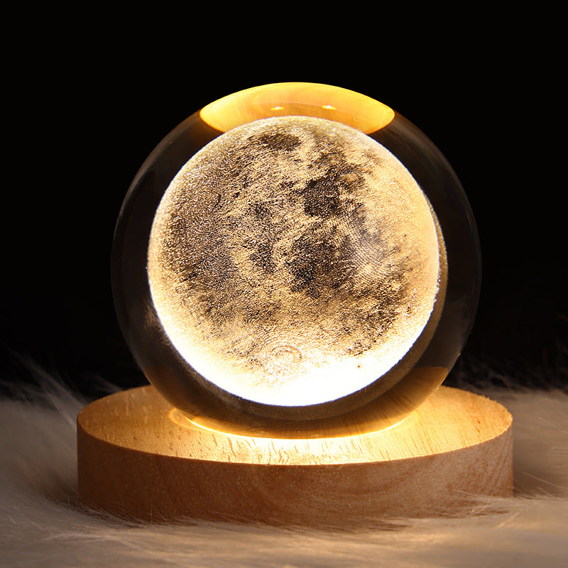 Moon lamp on a wooden base with a dark background