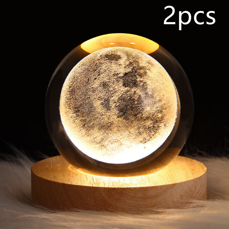 Two moon-shaped night lights on a wooden base with a dark background