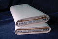 Two rolls of fabric with brand labels on a dark blue background
