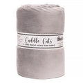 A rolled-up light gray plush fabric blanket with a paper label reading 'Cuddle Cuts' and 'Shampoon' on a white background.