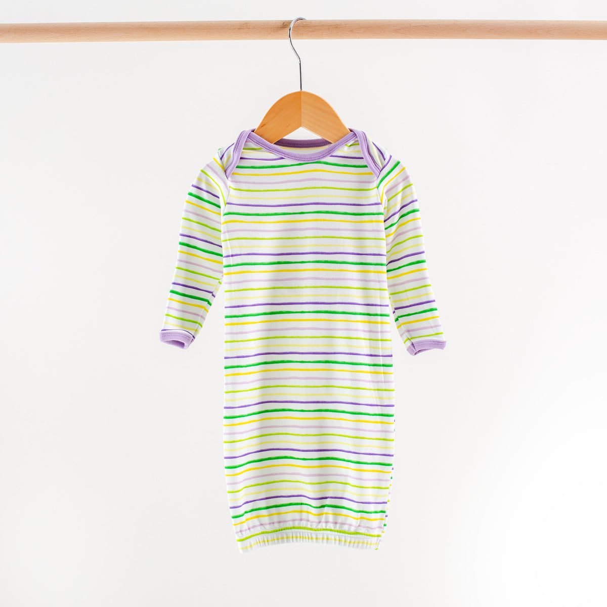 Striped baby dress on a hanger against a white background