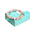 Peruvian pink opal bracelet on a teal box