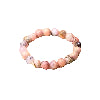 Pink opal jewelry displayed with flowers