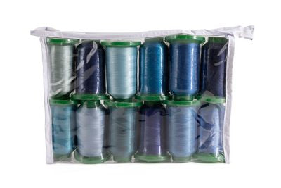 A clear plastic zippered pouch containing 12 spools of thread in various shades of blue, navy, and gray, arranged in two rows of six on a white background.