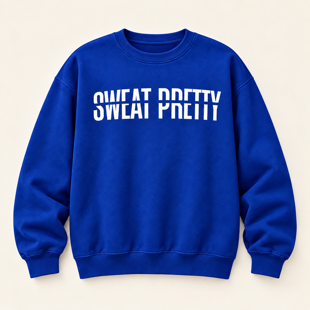 A royal blue crewneck sweatshirt with the phrase 'SWEAT PRETTY' printed in bold white letters across the chest, displayed flat against a light beige background.