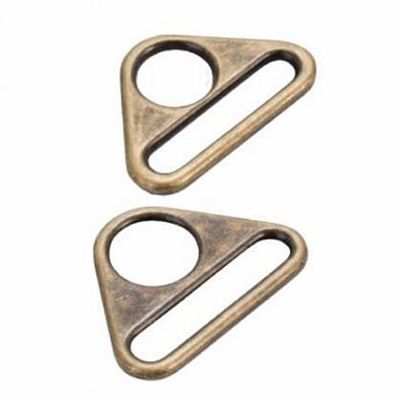 Two brass triangle-shaped metal hooks on a white background