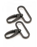 Two black metal carabiners on a white background