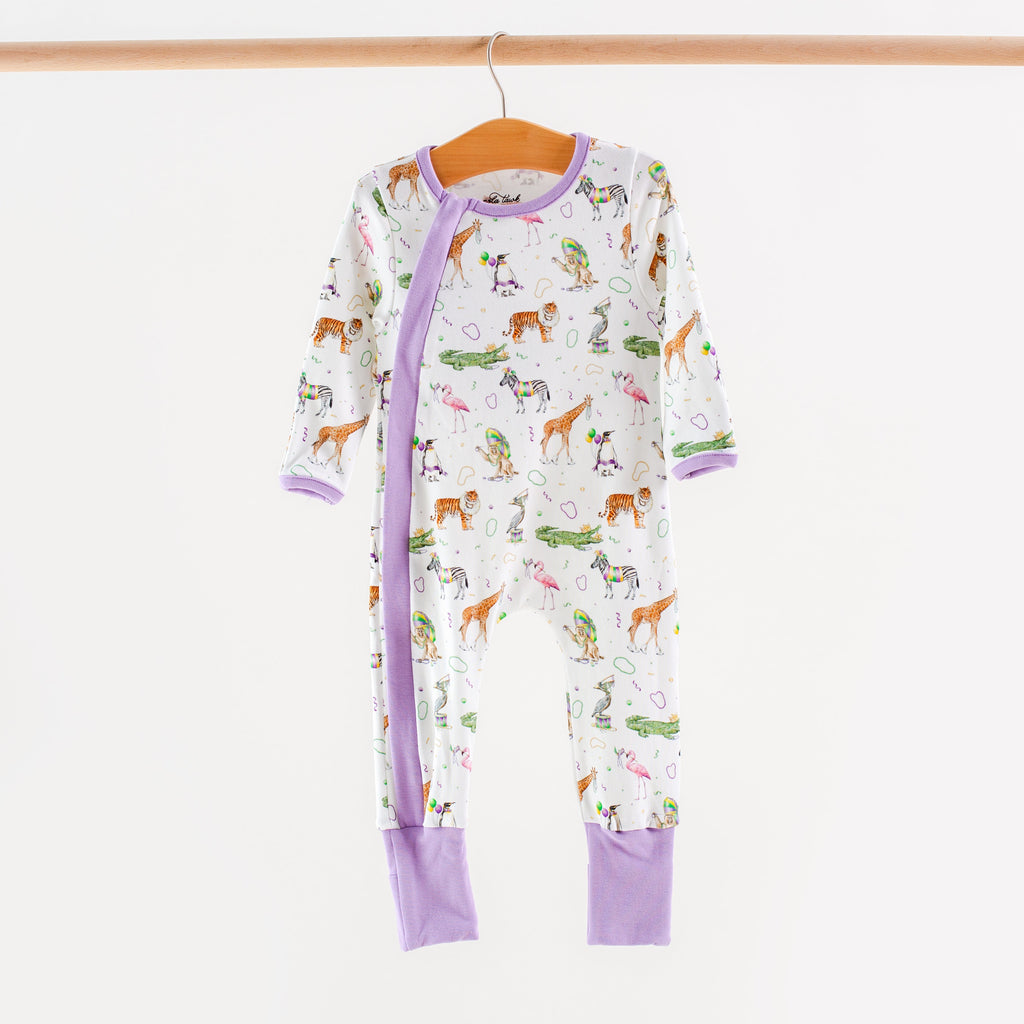 Children's onesie with animal pattern on a hanger against a white background