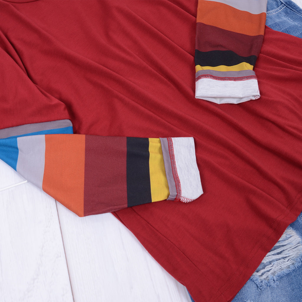 Colorful striped shirt on a red fabric background