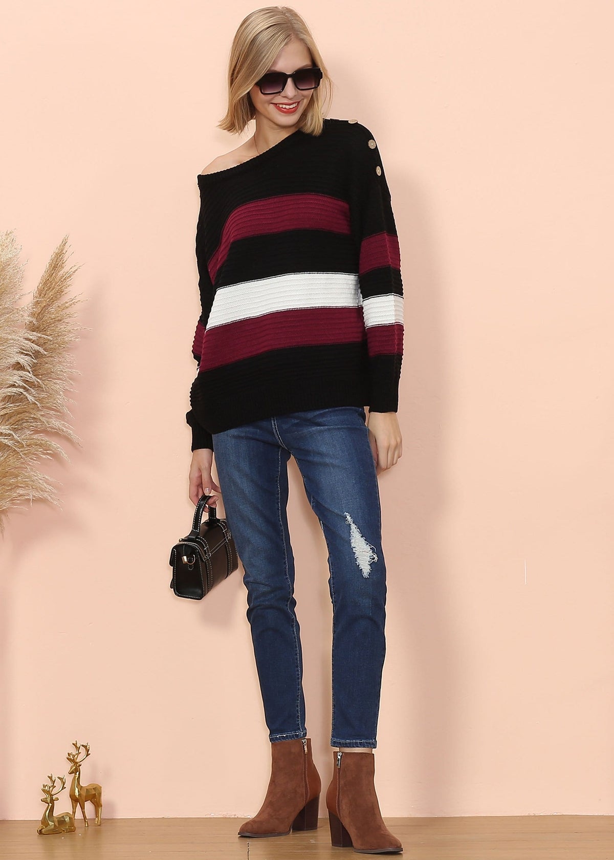 Woman wearing a striped sweater and jeans with a beige background