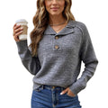 Woman wearing a gray sweater with buttons, holding a coffee cup on a white background
