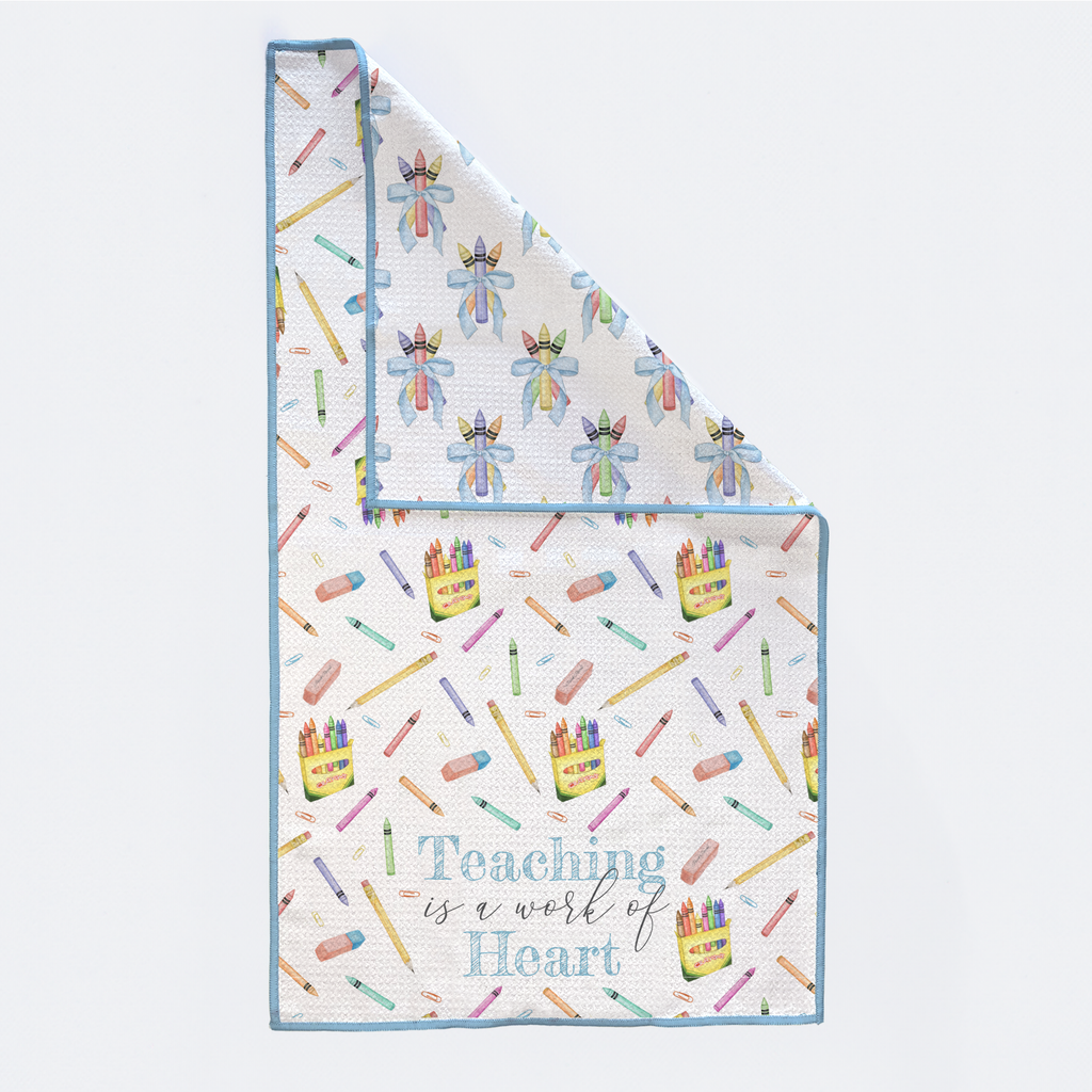 Baby blanket with colorful crayon pattern and 'Teaching is a work of heart' text on a white background
