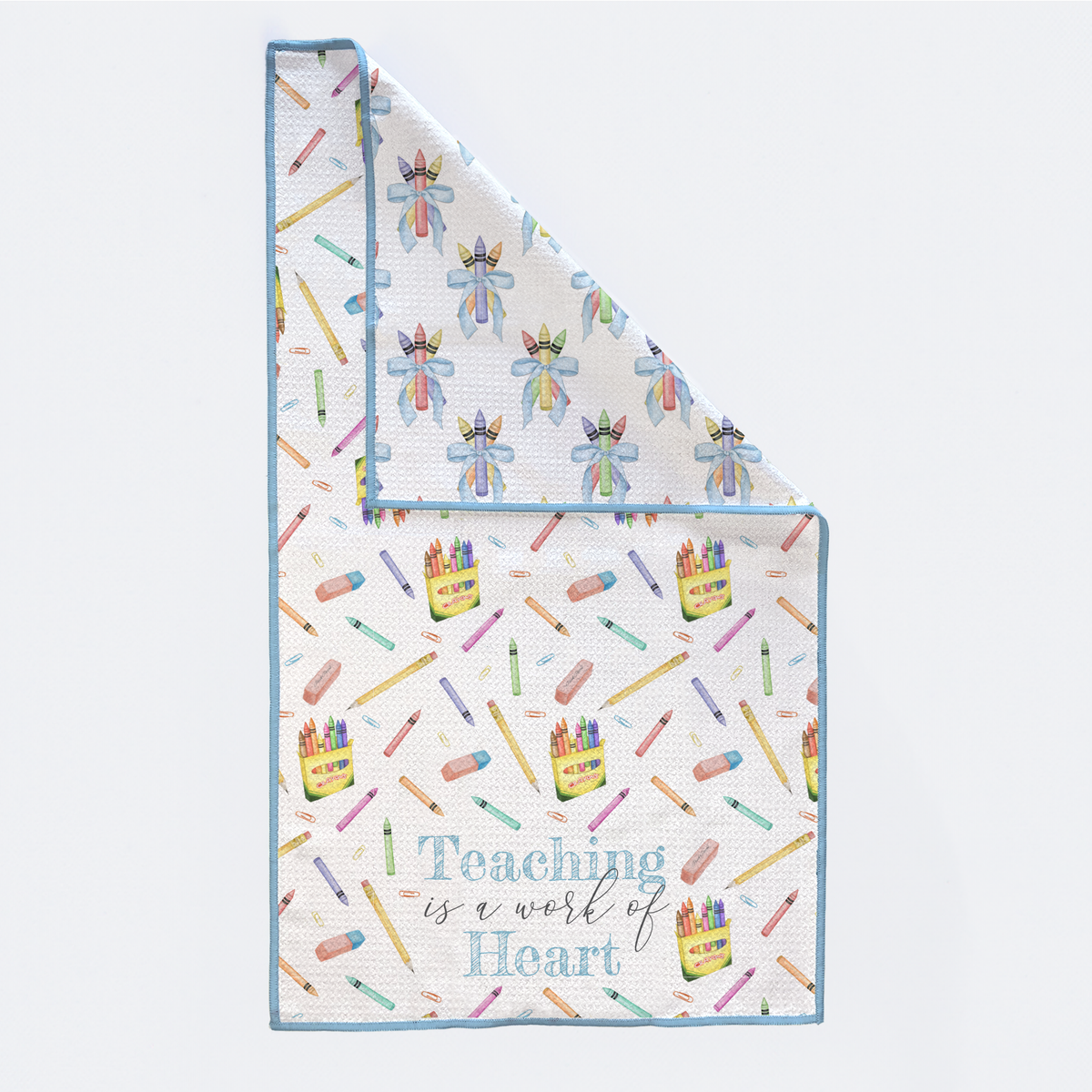 Baby blanket with colorful crayon pattern and 'Teaching is a work of heart' text on a white background