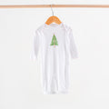 White long-sleeve shirt with a green tree design on a wooden hanger against a white background