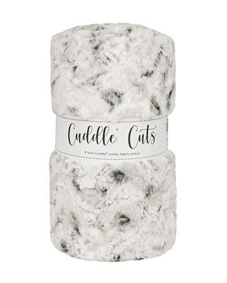 A folded plush faux fur blanket with a white and gray mottled pattern, wrapped in a white paper band that reads 'Cuddle Cuts'.