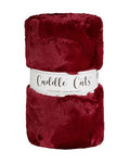 Red plush faux fur fabric with 'Cuddle Cuts' label on a white background