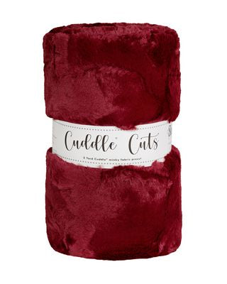Red plush faux fur fabric with 'Cuddle Cuts' label on a white background