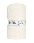 A rolled-up cream-colored plush fabric with a white paper band label that reads 'Cuddle Cuts'.