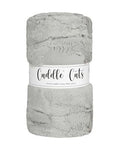 A folded plush faux fur fabric in a light gray color, wrapped with a white paper label that reads 'Cuddle Cats'.