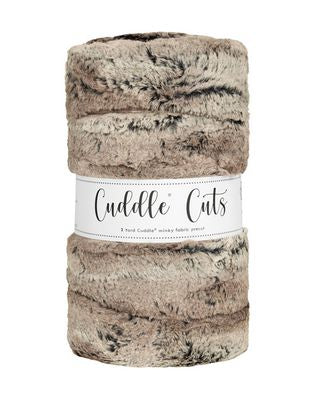 Cozy Cuddle Cuts plush off-white, tan, and brown fabric with label on a white background