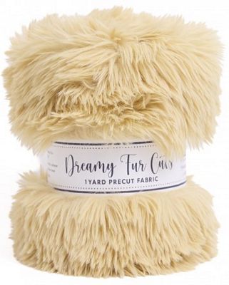 A ball of cream-colored faux fur fabric with a white paper label reading 'Dreamy Fur Co 1 Yard Precut Fabric' on a white background.
