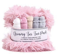 A pink fluffy faux-fur wrapped gift set labeled 'Dreamy Fur Fun Pack,' containing five rolled precut pieces in white, pink, beige, gray, and blue-gray, on a white background.