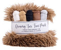 Dreamy Fur Fun Pack containing a fluffy brown faux fur blanket and five pre-cut cozy pieces in white, tan, charcoal, brown, and light gray, wrapped in a white paper band.