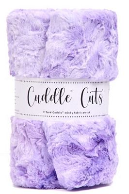 A folded lavender purple fuzzy plush fabric with a white paper label wrapped around the middle that reads 'Cuddle Cuts'.