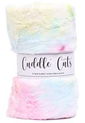 A folded plush faux-fur blanket with a pastel rainbow tie-dye pattern, wrapped in a white paper band labeled 'Cuddle Cuts'.