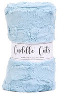 A light blue plush throw blanket rolled up with a white paper band label that reads 'Cuddle Cuts'.