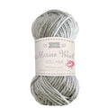 Ball of gray yarn with a label on a white background