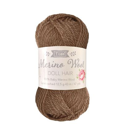 Brown yarn ball with a label on a white background