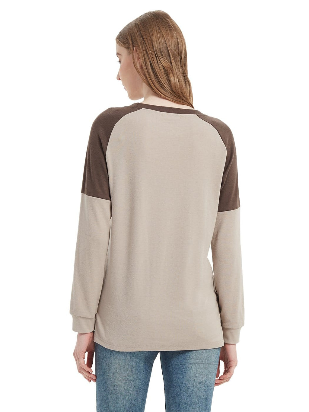 Woman wearing a beige and brown long-sleeve shirt on a white background