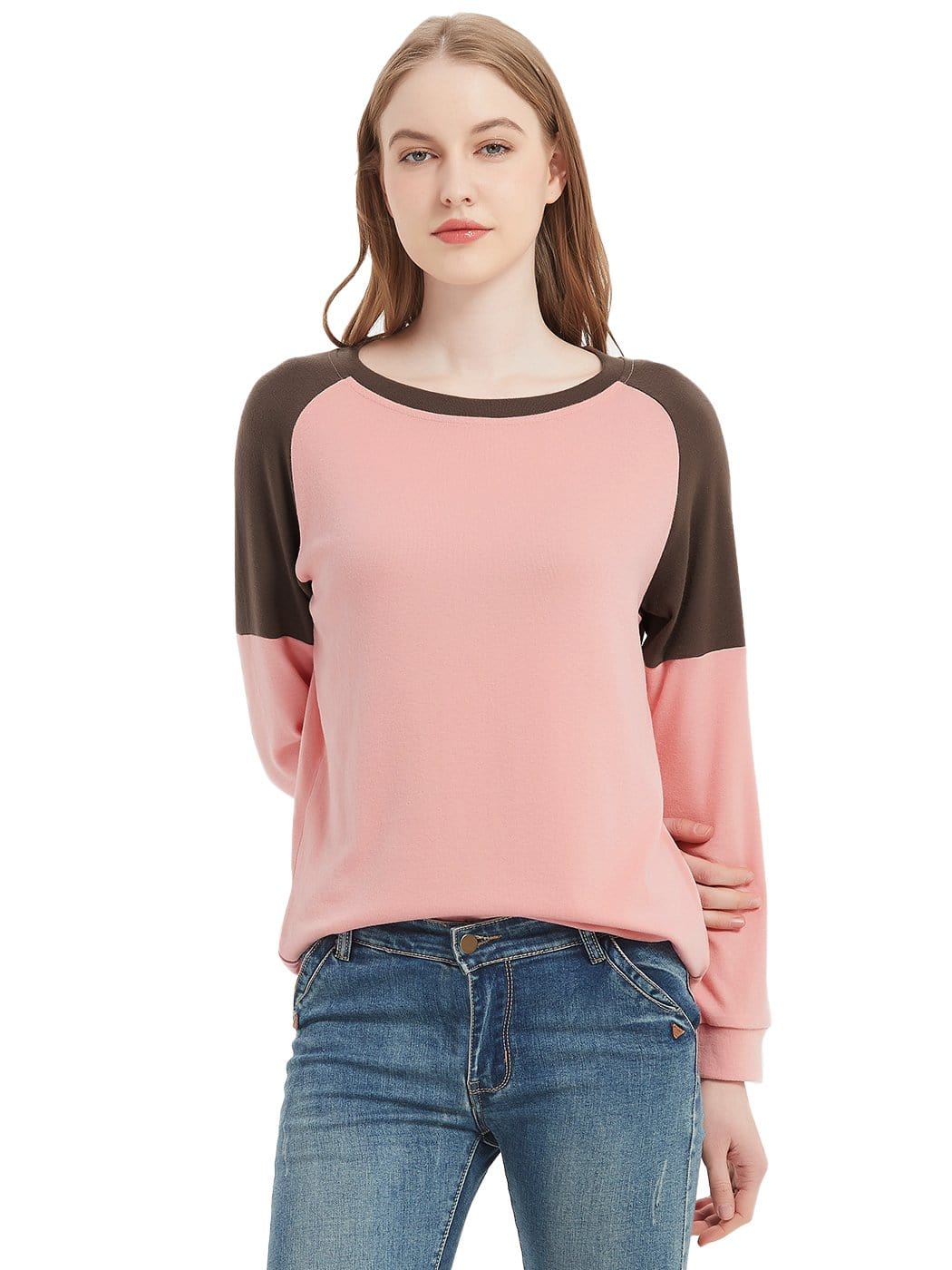 Woman wearing a pink and brown long-sleeve shirt with blue jeans on a white background