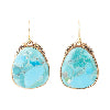 Turquoise stone earrings with gold frames on a white background