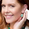 Woman wearing turquoise earrings and necklace