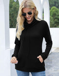 Woman wearing a black cowl-neck sweater and sunglasses outdoors.