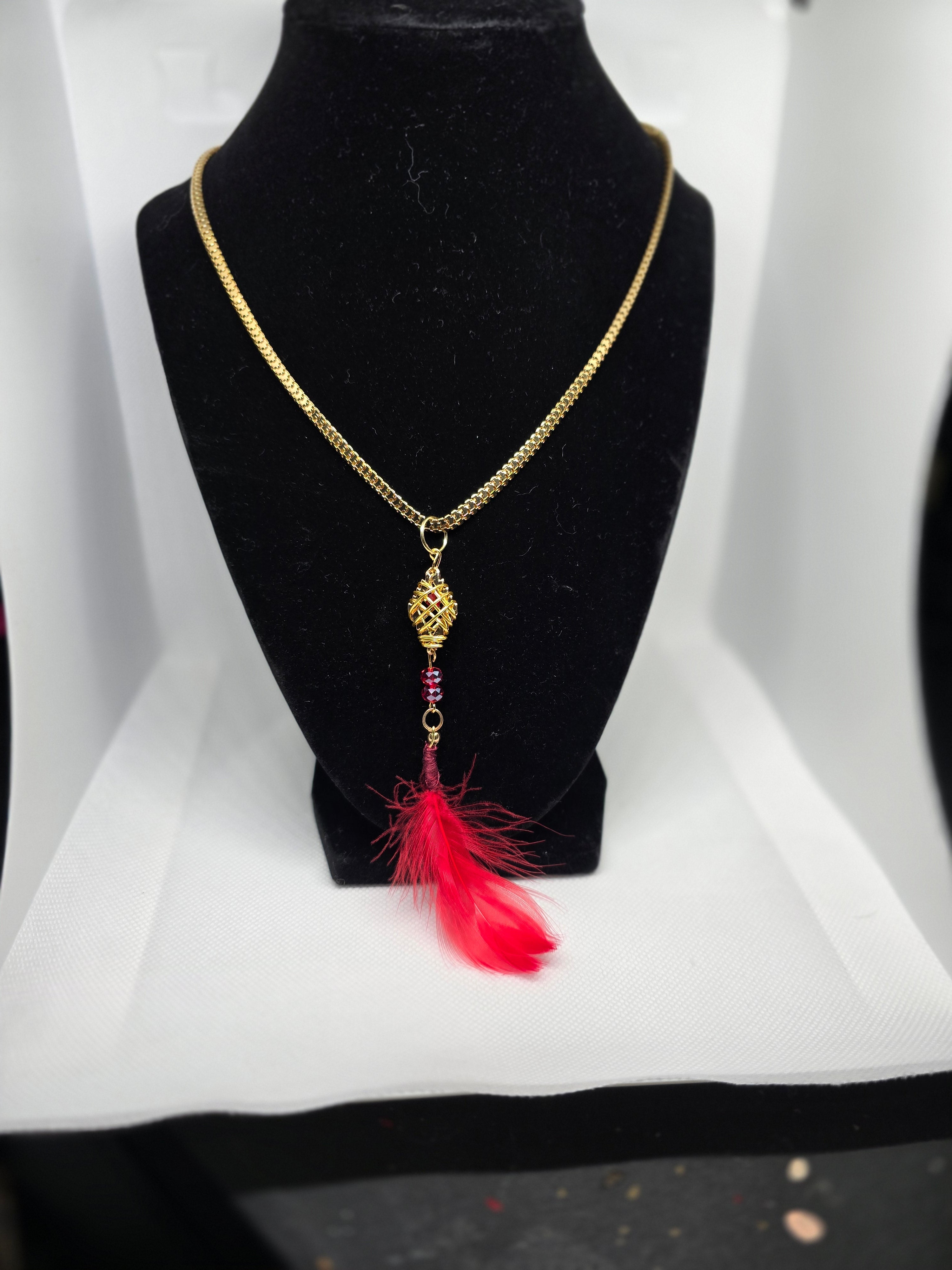 Golden Colored Diamond Shaped Basket Pendant With Red Feather on a Golden Color  Plastic Snake Chain